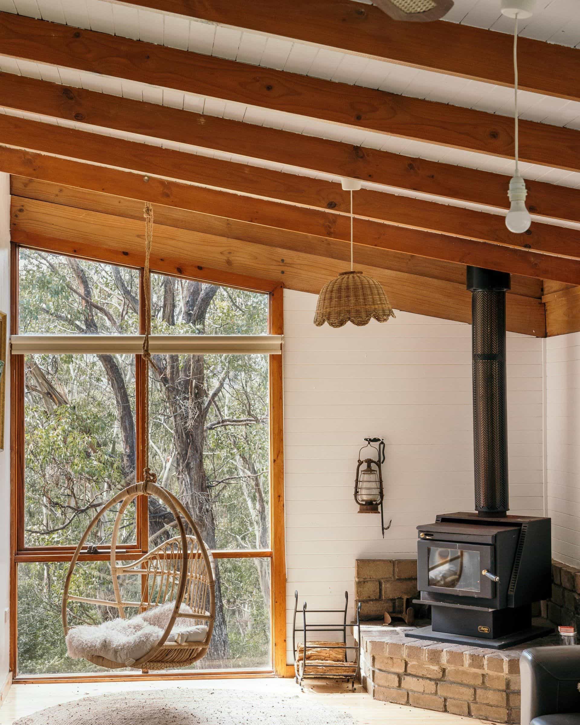 Log fire and hanging chair at Glenaire Cottages