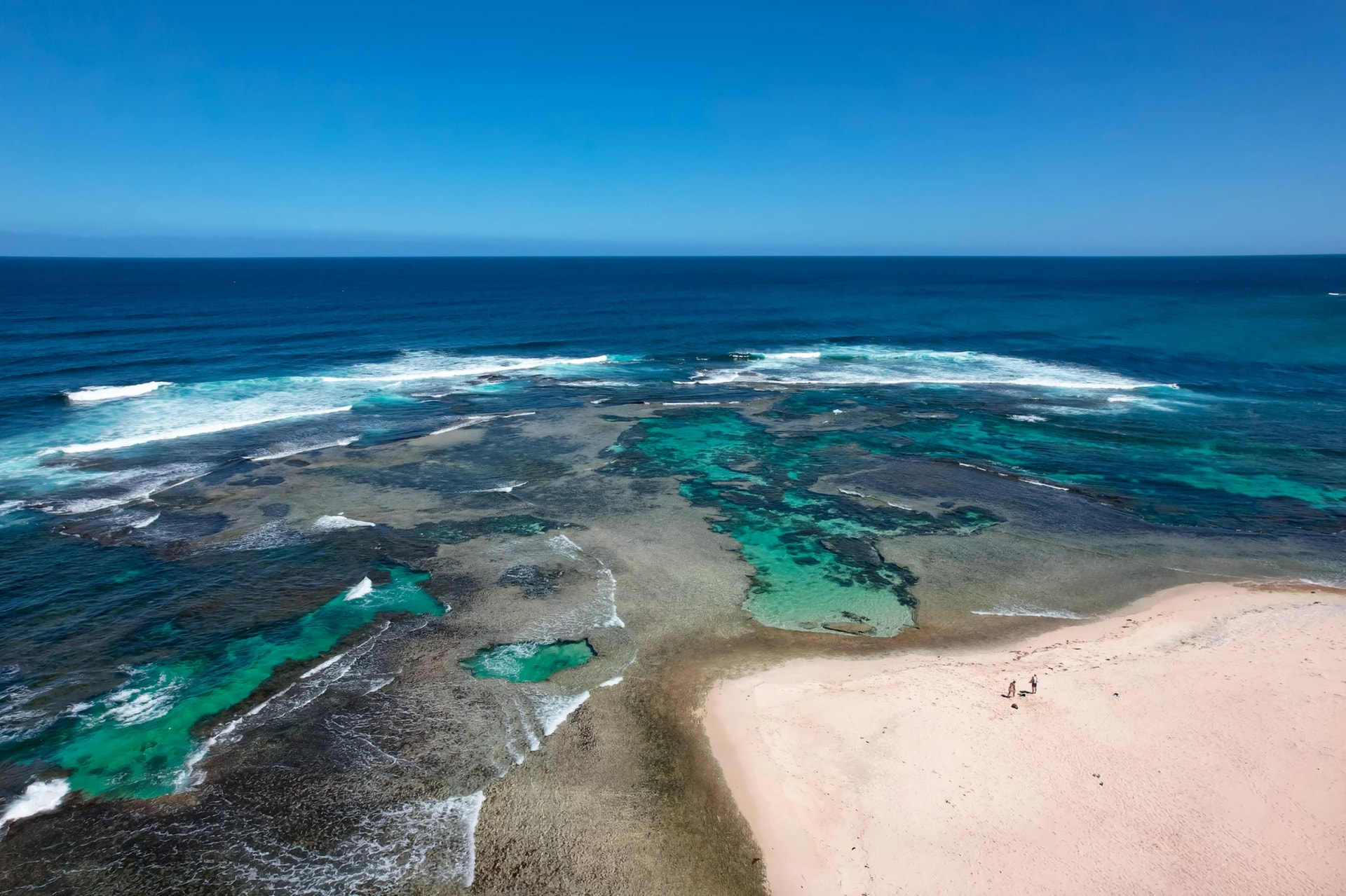 A couple walking the beach at Surfers Point